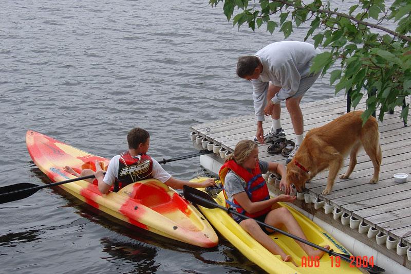 people in kayaks near a dock