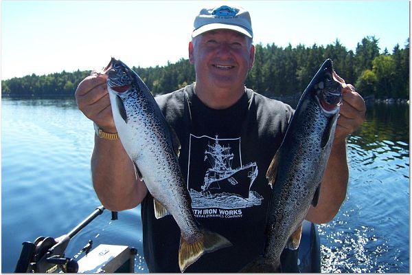 Holding two salmon